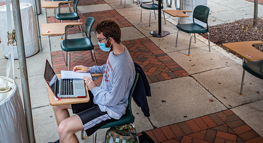 Student working on a laptop outdoors